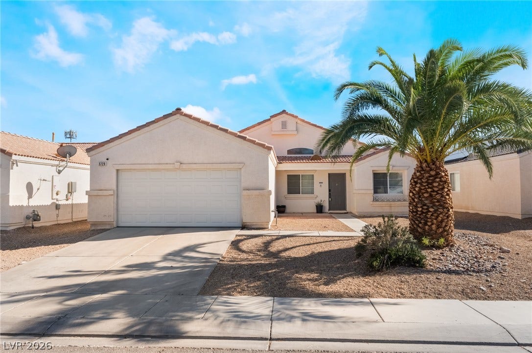 3729 Shimmering Creek Avenue, North Las Vegas, NV 89031 Palm trees frame this classic stucco home with an attached double garage.