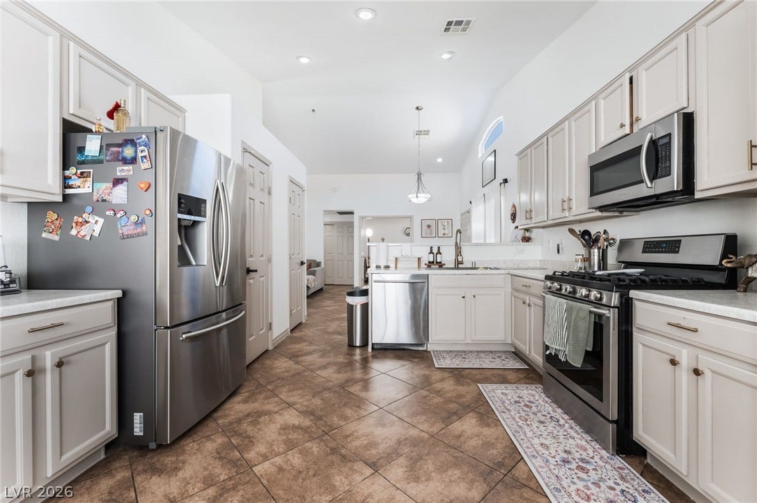 3729 Shimmering Creek Avenue, North Las Vegas, NV 89031 Gleaming tile floors run throughout this culinary space featuring ample cabinetry and recessed lighting.