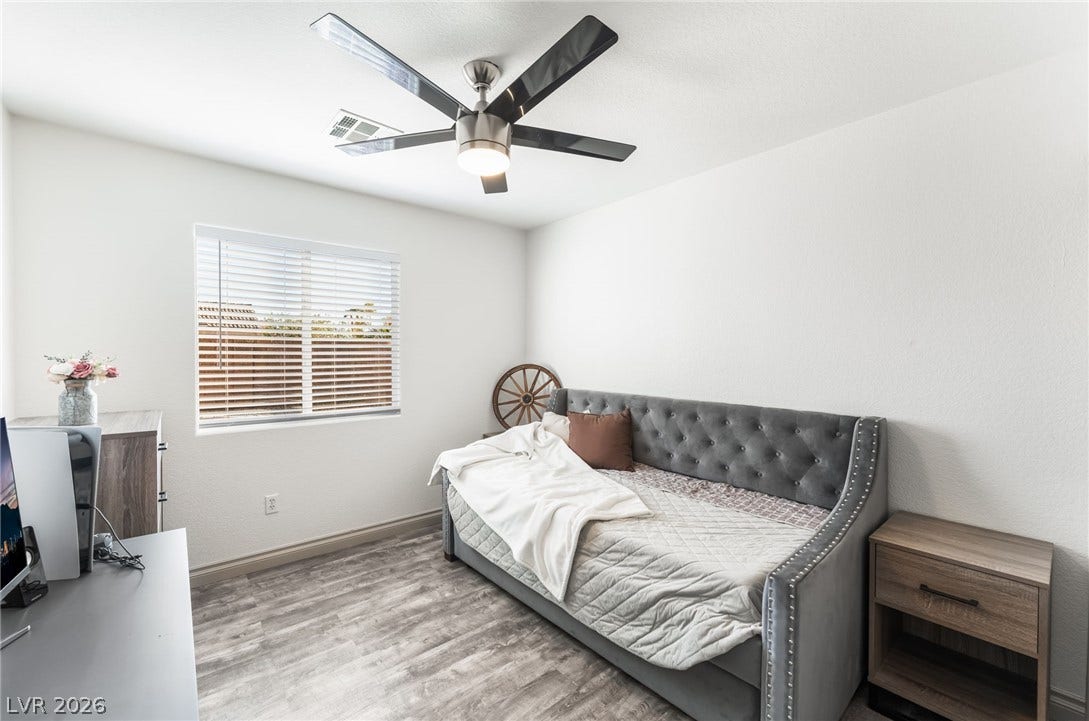 3729 Shimmering Creek Avenue, North Las Vegas, NV 89031 Gleaming wood-look floors anchor this versatile secondary bedroom filled with natural light.