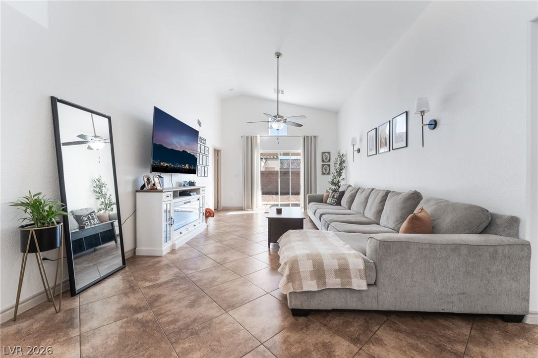 3729 Shimmering Creek Avenue, North Las Vegas, NV 89031 High vaulted ceilings and durable tile flooring highlight this welcoming living area.
