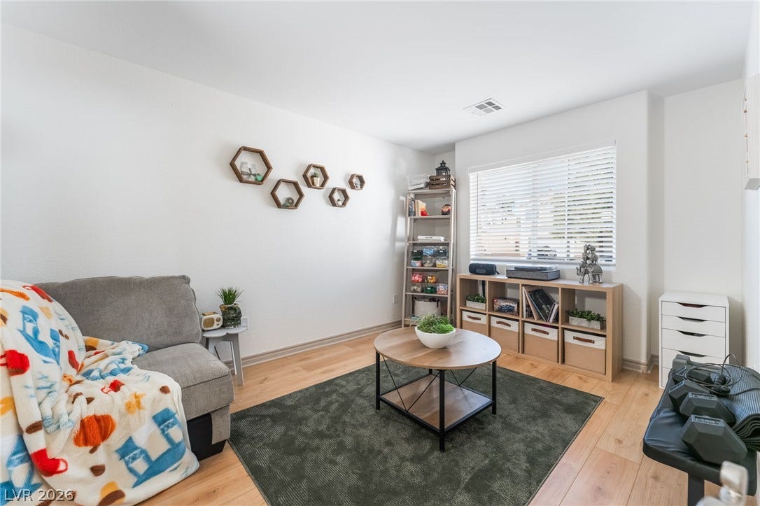 3729 Shimmering Creek Avenue, North Las Vegas, NV 89031 Smooth wood-plank flooring pairs with a large window for a bright, clean look.