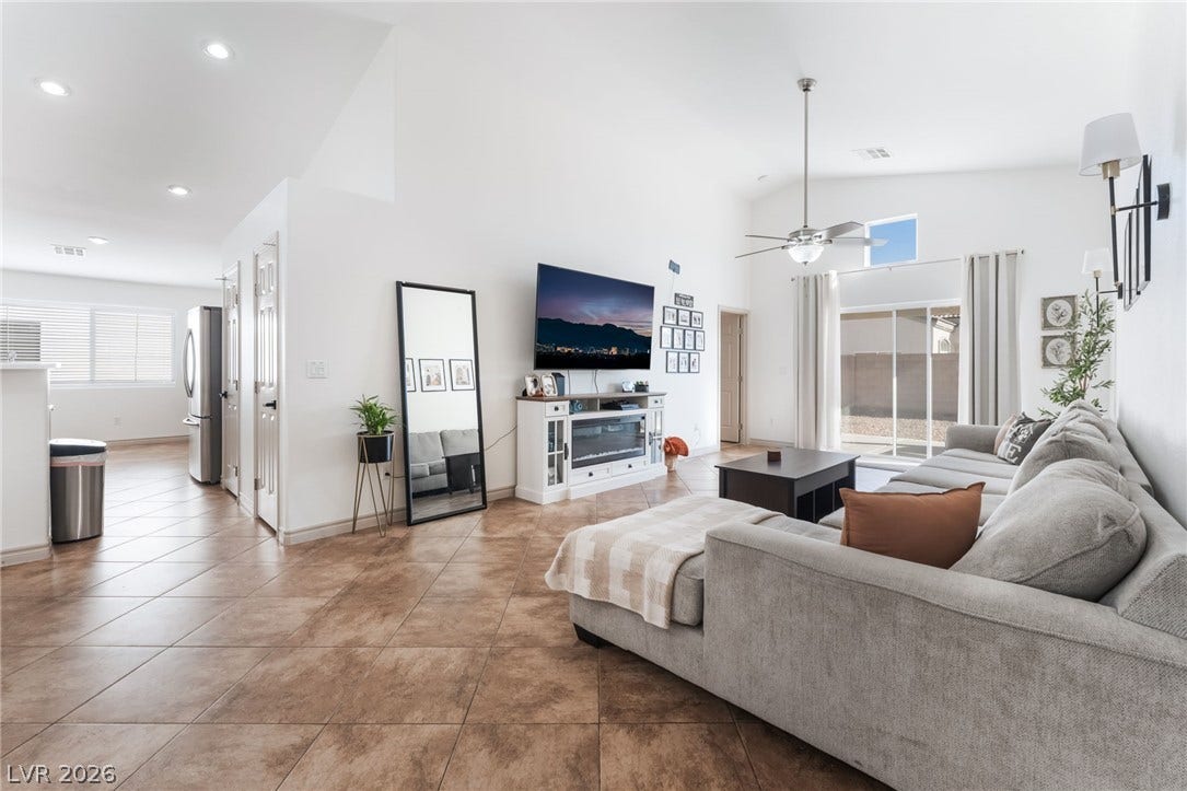 3729 Shimmering Creek Avenue, North Las Vegas, NV 89031 Gleaming tile floors and soaring vaulted ceilings define this airy living space.