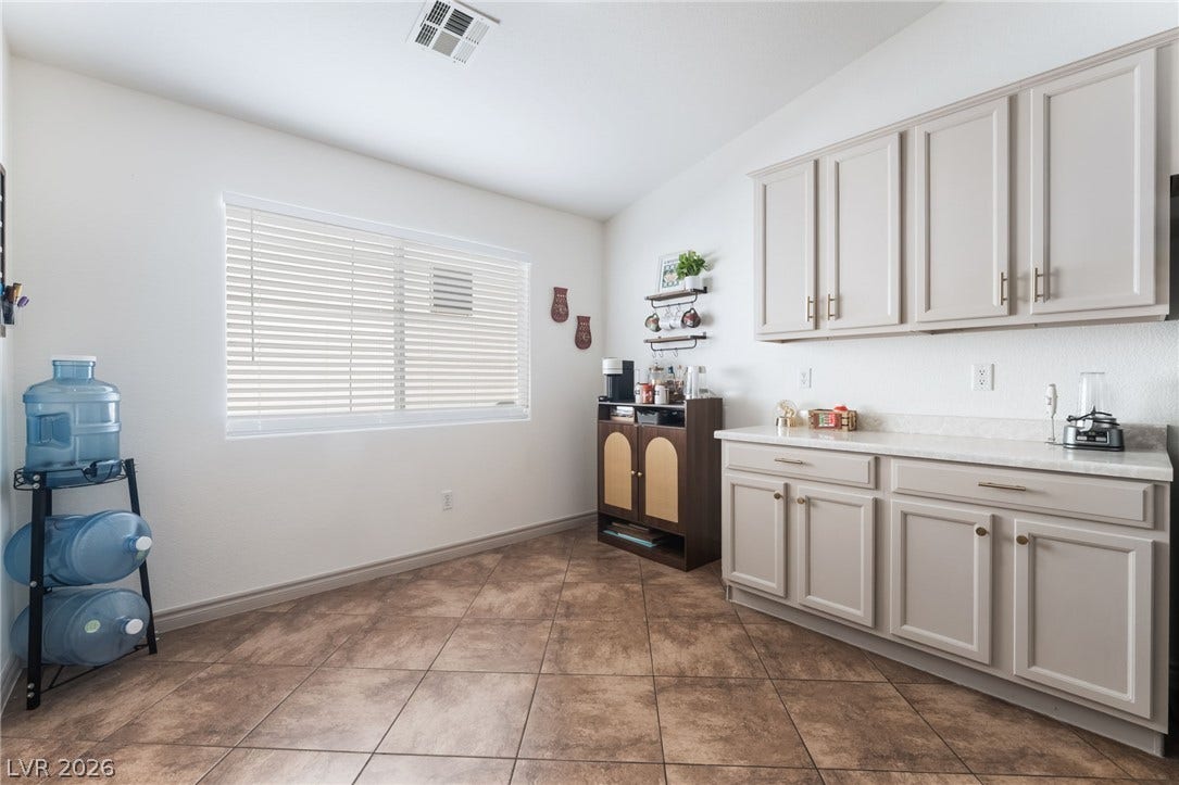 3729 Shimmering Creek Avenue, North Las Vegas, NV 89031 Warm tile flooring runs throughout this versatile space flanked by abundant built-in cabinetry.
