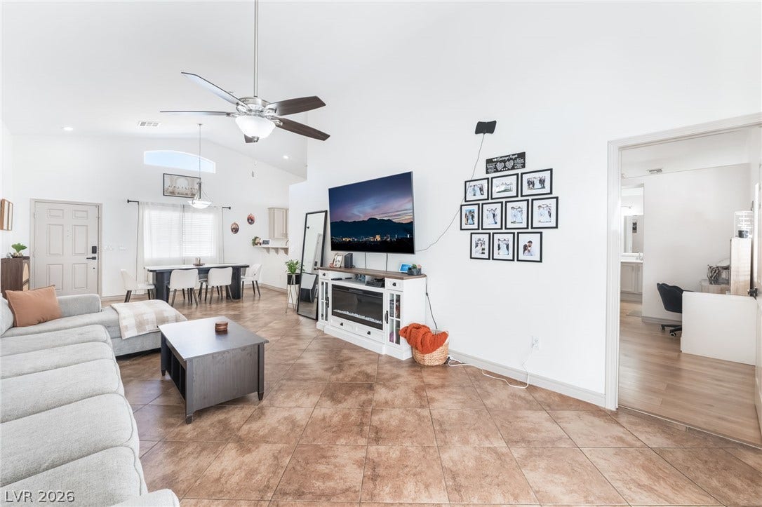 3729 Shimmering Creek Avenue, North Las Vegas, NV 89031 An open floor plan connects the living area to the dining space under vaulted ceilings.