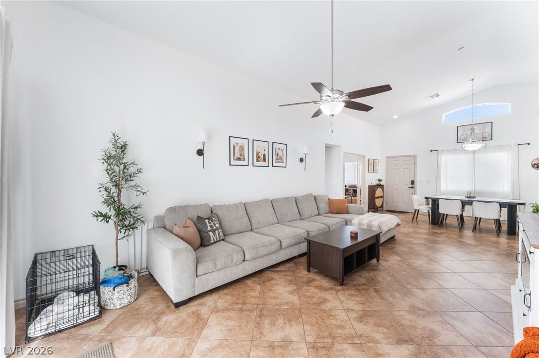 3729 Shimmering Creek Avenue, North Las Vegas, NV 89031 Soaring vaulted ceilings and expansive tile flooring define this open-concept main living area.