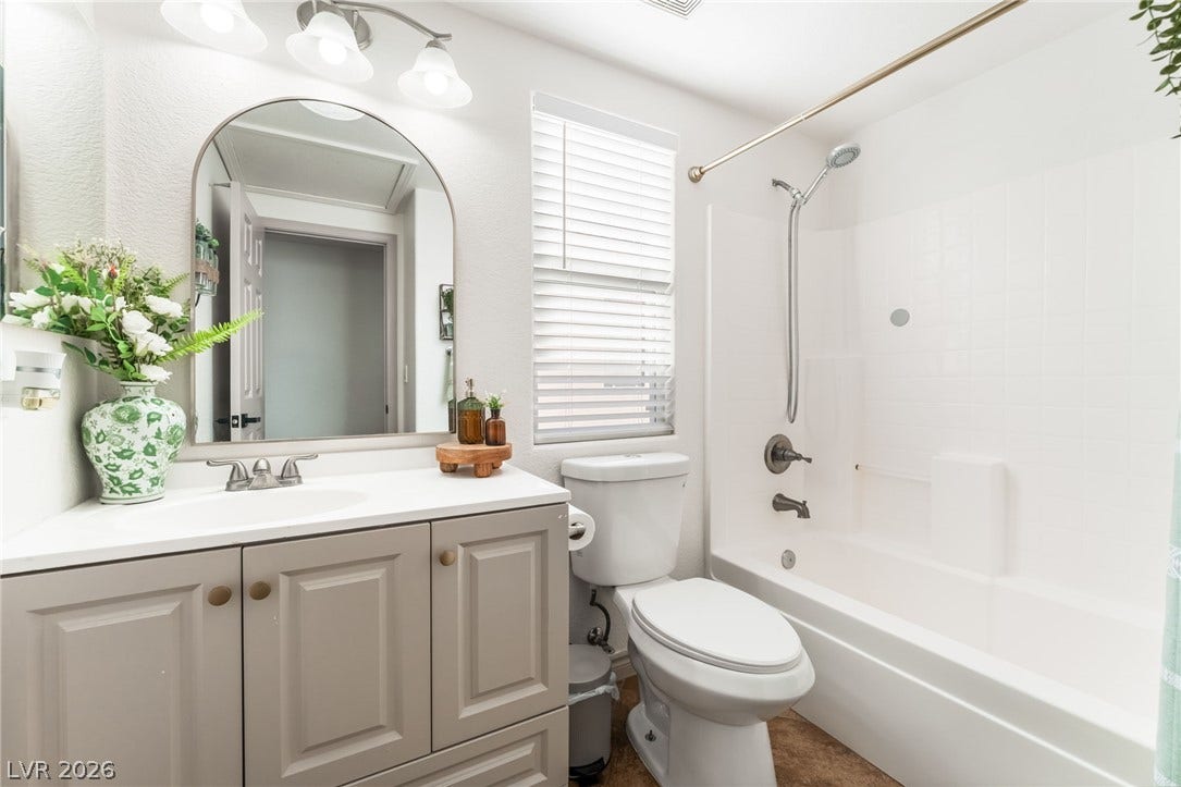 3729 Shimmering Creek Avenue, North Las Vegas, NV 89031 A classic tub and shower combination sits adjacent to a modern single vanity.