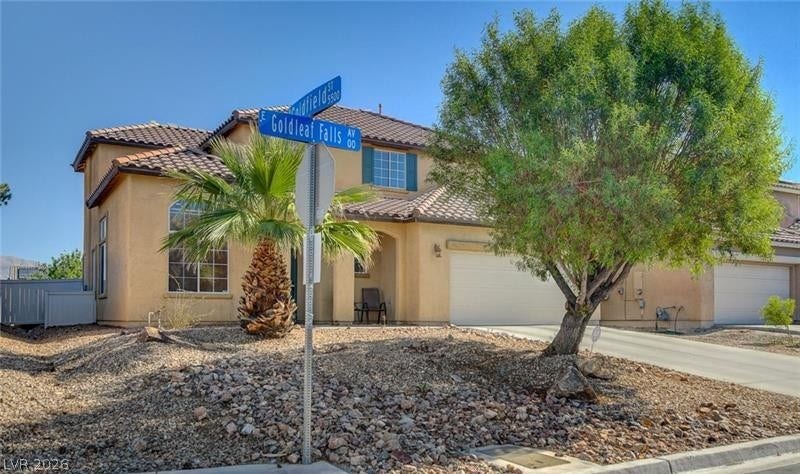 4 Goldleaf Falls Avenue, North Las Vegas, NV 89031 Stucco exterior and tile roofing showcase classic desert architecture on a prominent corner lot.
