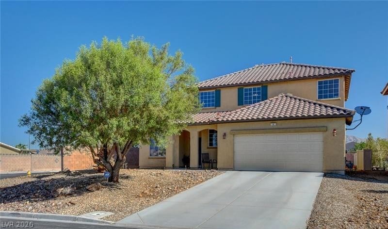 4 Goldleaf Falls Avenue, North Las Vegas, NV 89031 An attractive tiled roof and concrete driveway enhance the architectural character of this two-story home.