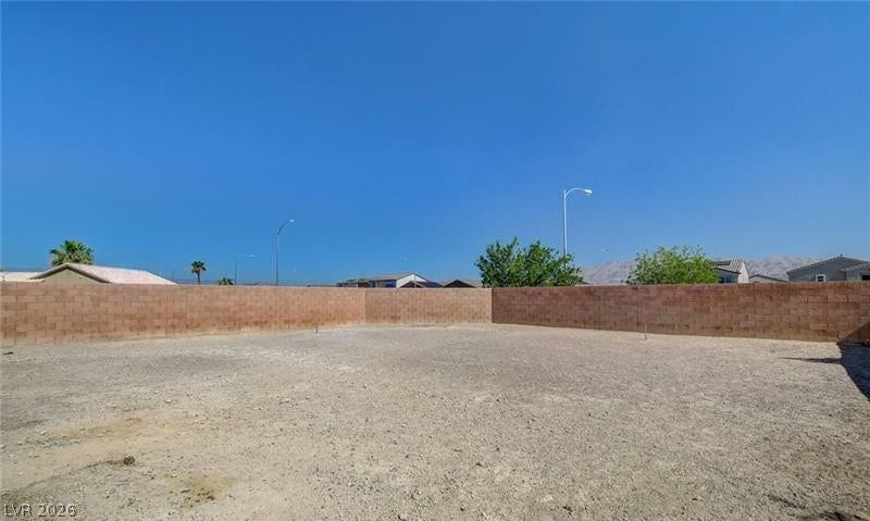 4 Goldleaf Falls Avenue, North Las Vegas, NV 89031 An expansive gravel yard comes fully enclosed by a substantial block privacy wall.