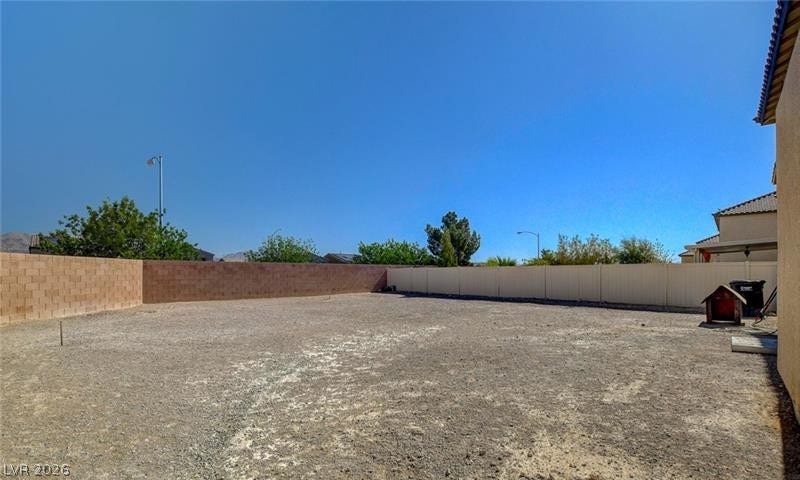 4 Goldleaf Falls Avenue, North Las Vegas, NV 89031 A spacious backyard enclosed by durable block and vinyl fencing offers a blank canvas.