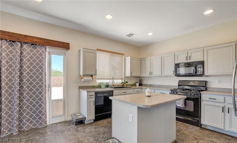 4 Goldleaf Falls Avenue, North Las Vegas, NV 89031 Recessed lighting illuminates this functional culinary space featuring custom tile flooring and stone counters.