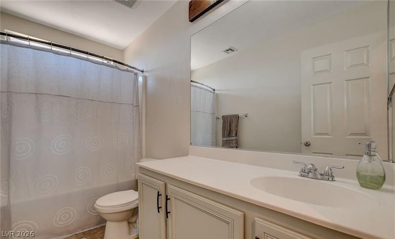 4 Goldleaf Falls Avenue, North Las Vegas, NV 89031 A spacious vanity features a wide mirror and classic cabinetry in this bathroom.