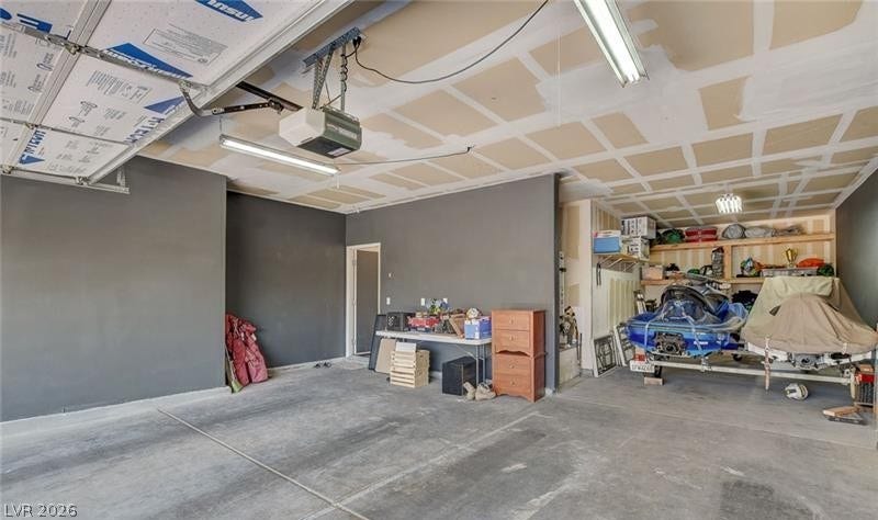 4 Goldleaf Falls Avenue, North Las Vegas, NV 89031 Concrete flooring and an automatic garage door opener define this functional storage space.