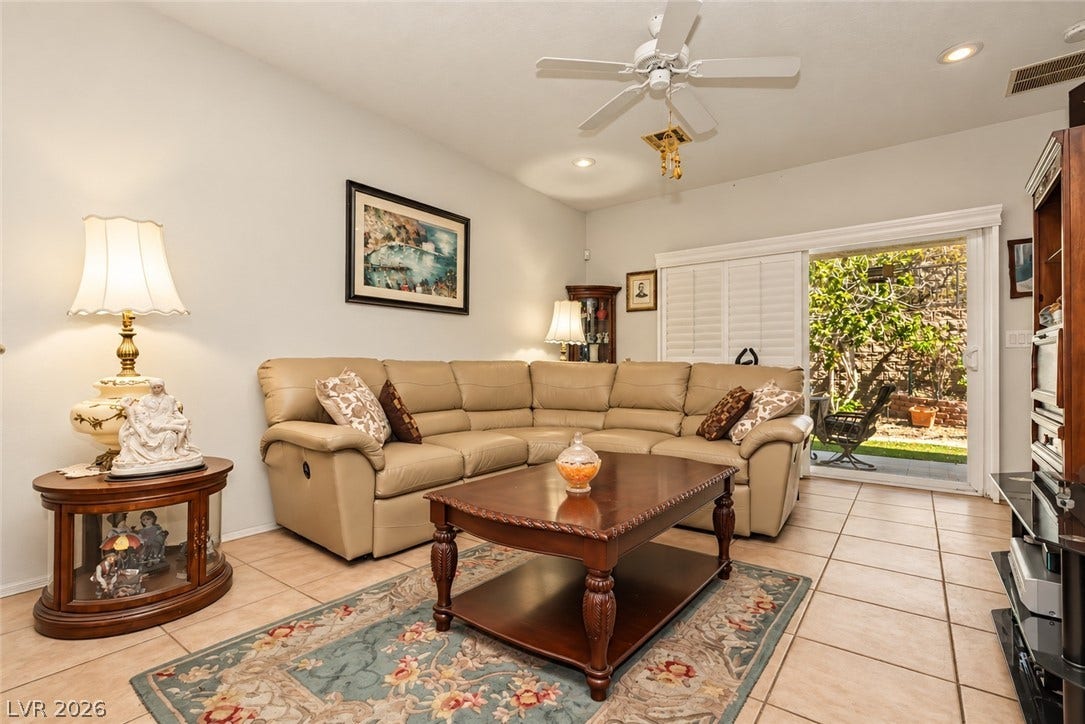 Tile flooring and sliding glass doors enhance this welcoming living space.