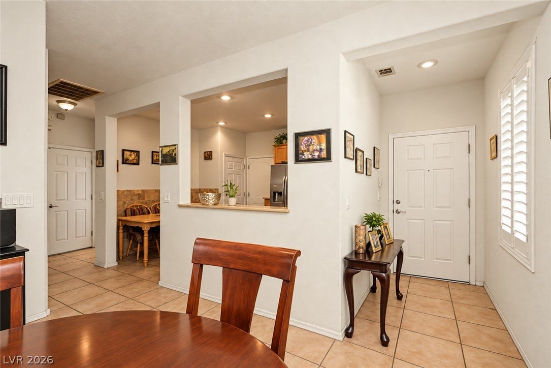 Tiled flooring spans from the welcoming entry foyer into the open dining areas.