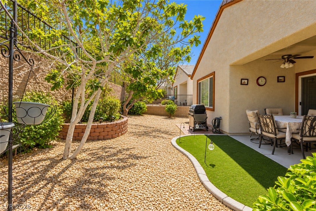 A low-maintenance gravel yard and sheltered dining patio offer comfortable outdoor living space.