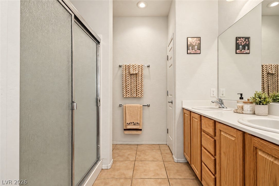 Tile flooring and a long double vanity define this functional bathroom layout.