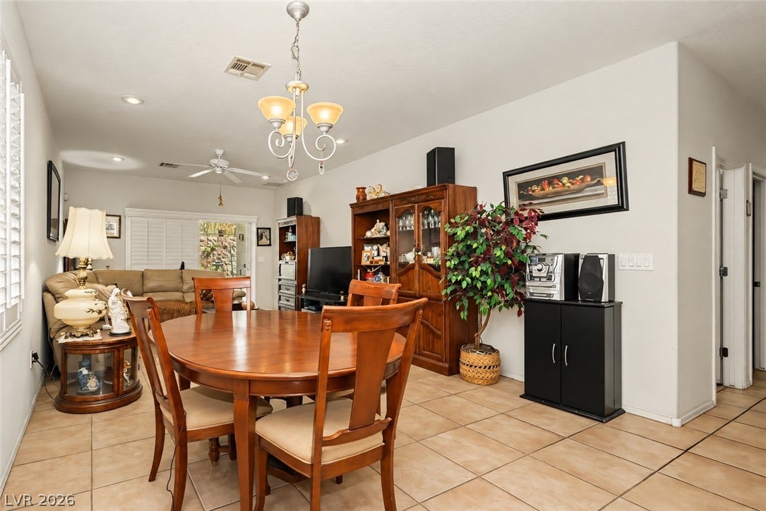 Tiled flooring and natural light create a welcoming dining space with an open-concept flow.