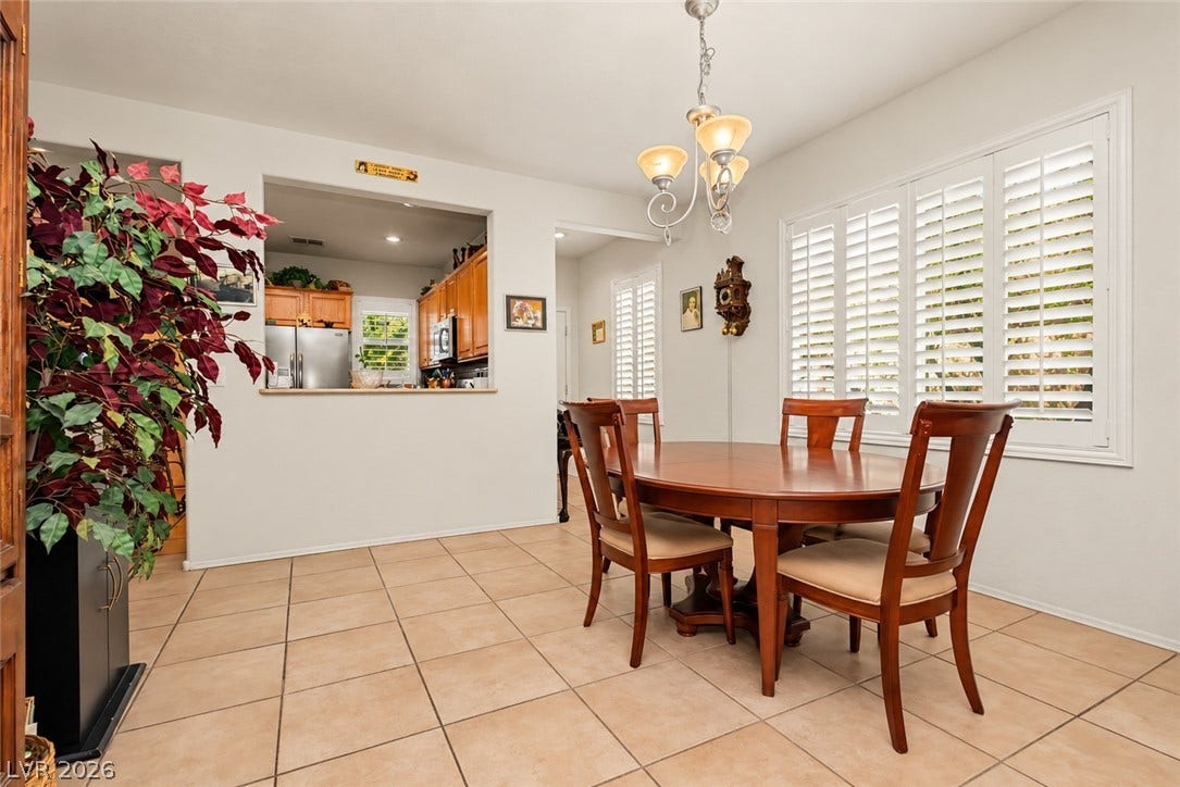 Tiled flooring and classic plantation shutters define this welcoming dining space.