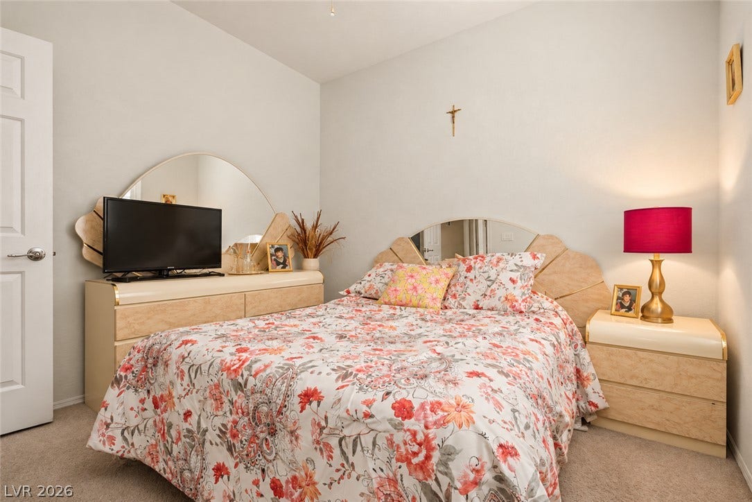 Plush carpeting and neutrally toned walls maximize comfort in this cozy bedroom retreat.