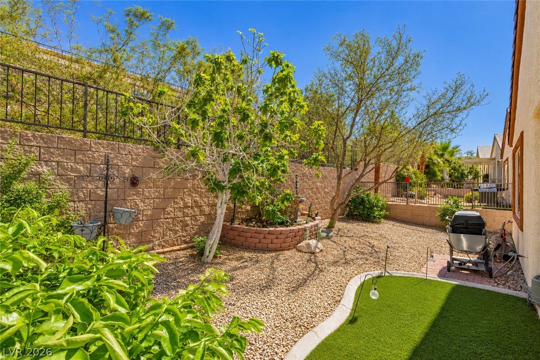 A terraced retaining wall and gravel ground cover define this low-maintenance outdoor space.