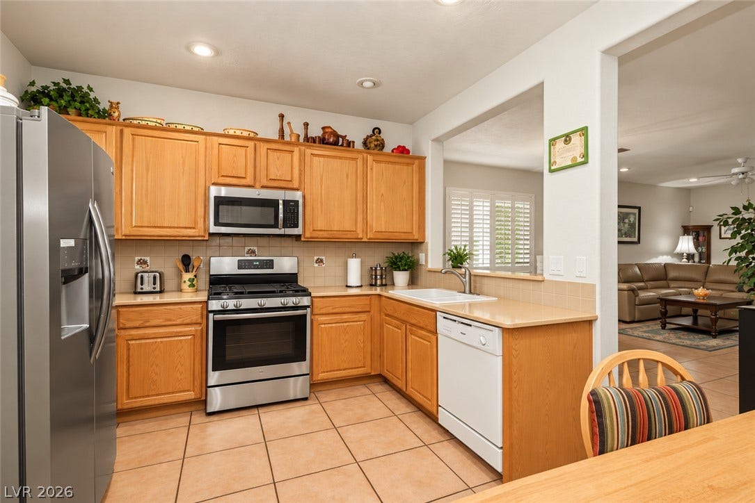 Warm wood cabinetry and tile flooring define this highly functional kitchen space.
