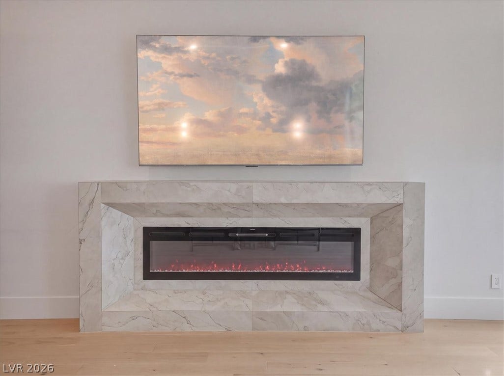 3 Isleworth Drive, Henderson, NV 89052 A refined electric fireplace with a marble surround creates a warm focal point.