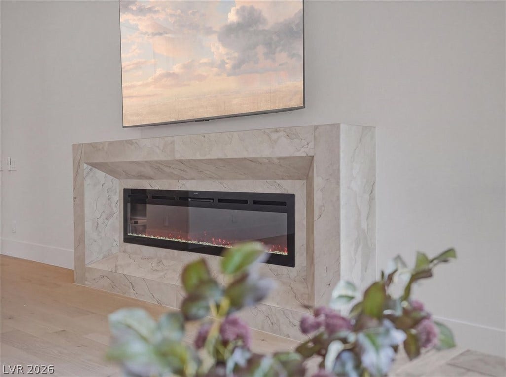 3 Isleworth Drive, Henderson, NV 89052 A modern fireplace with a sleek design anchors this inviting living space.