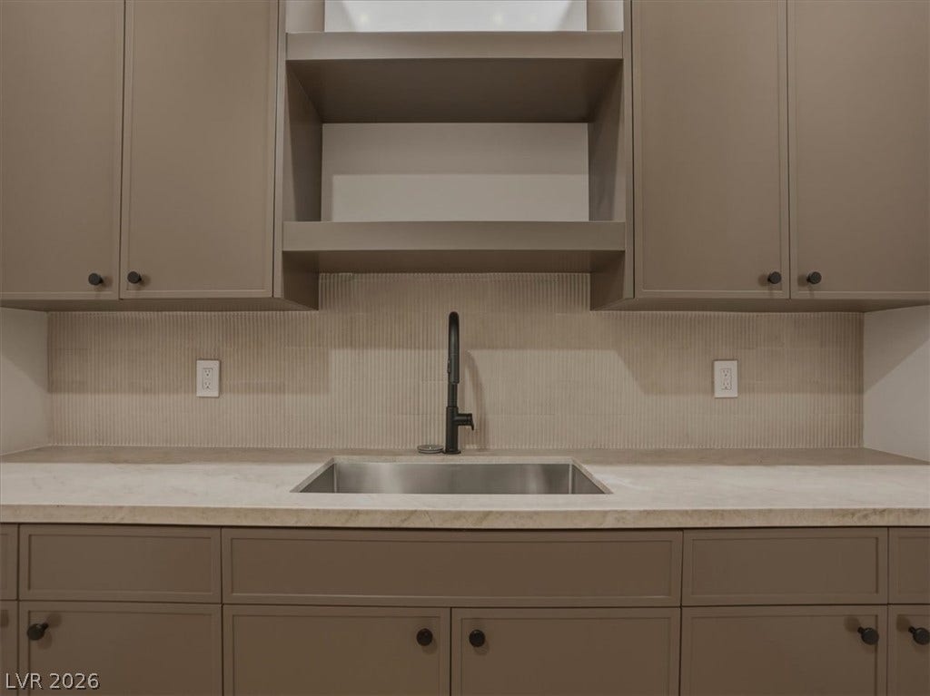 3 Isleworth Drive, Henderson, NV 89052 A well-appointed kitchen showcasing stylish cabinetry and a sophisticated sink with contemporary fixtures.