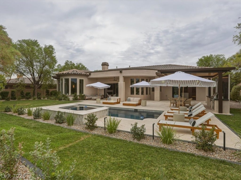 3 Isleworth Drive, Henderson, NV 89052 A spacious outdoor living area offers a private pool, spa, and outdoor kitchen, perfect for entertaining.