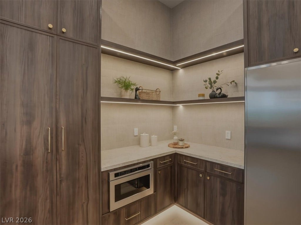 3 Isleworth Drive, Henderson, NV 89052 A well-appointed kitchen pantry offers abundant storage, built-in appliances, and sleek, integrated lighting.