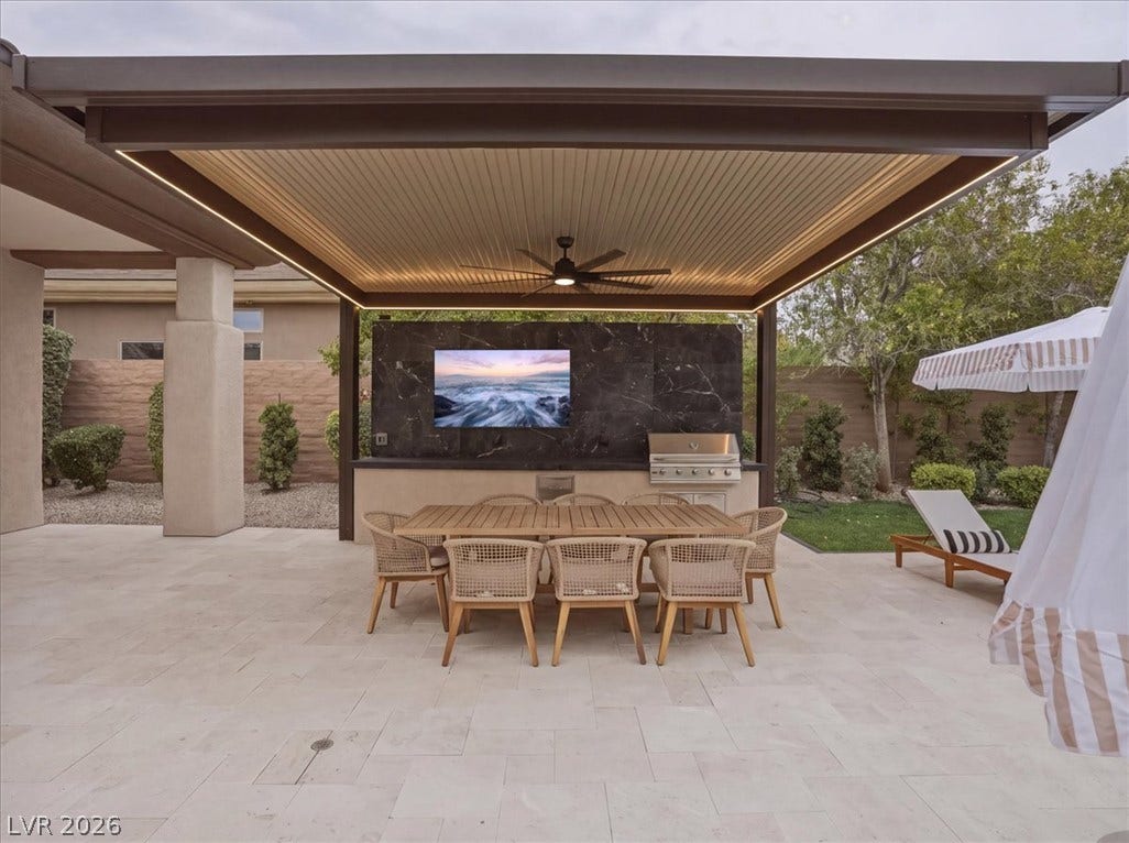 3 Isleworth Drive, Henderson, NV 89052 An inviting outdoor dining area features a built-in barbecue and a spacious patio, ideal for entertaining.