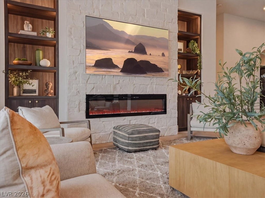 3 Isleworth Drive, Henderson, NV 89052 A refined living space features built-in shelving flanking a textured stone fireplace with a contemporary linear insert.