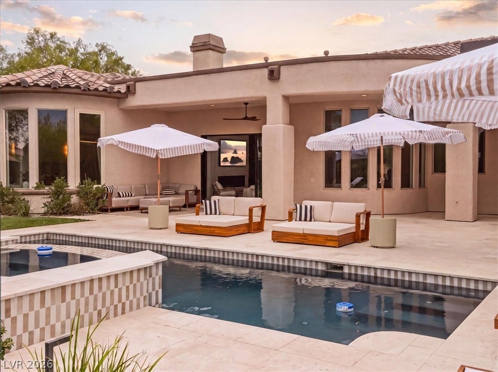 3 Isleworth Drive, Henderson, NV 89052 An inviting backyard oasis offers a sparkling pool and extensive patio space for relaxation and entertaining.