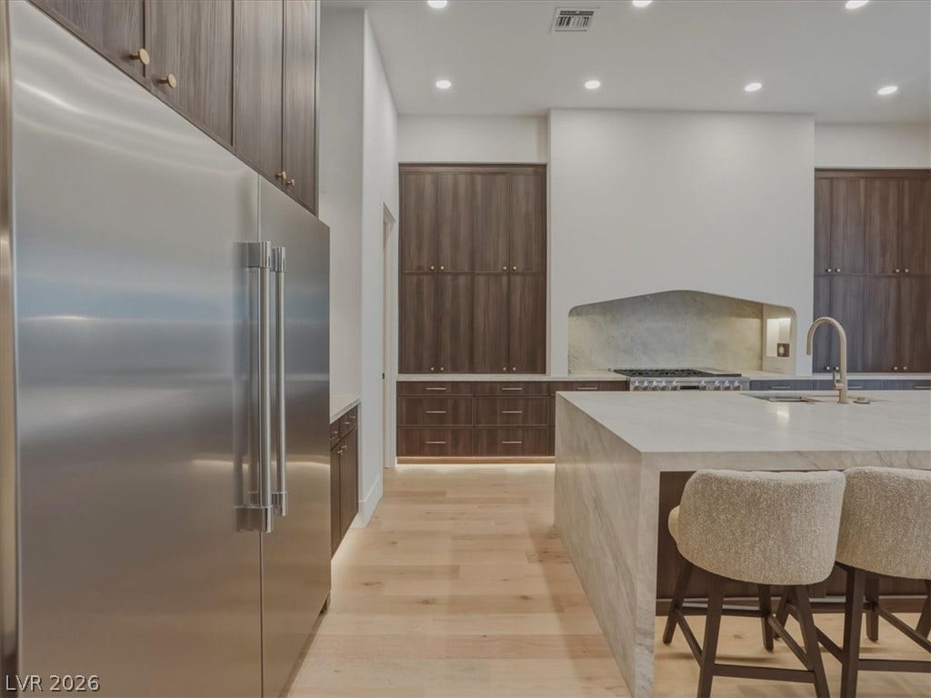 3 Isleworth Drive, Henderson, NV 89052 A refined kitchen showcasing a large center island and premium stainless steel appliances.