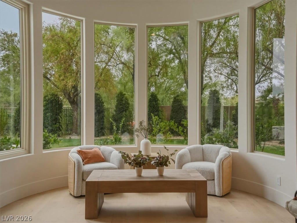 3 Isleworth Drive, Henderson, NV 89052 A graceful bay window seating area offers serene views of the verdant backyard.