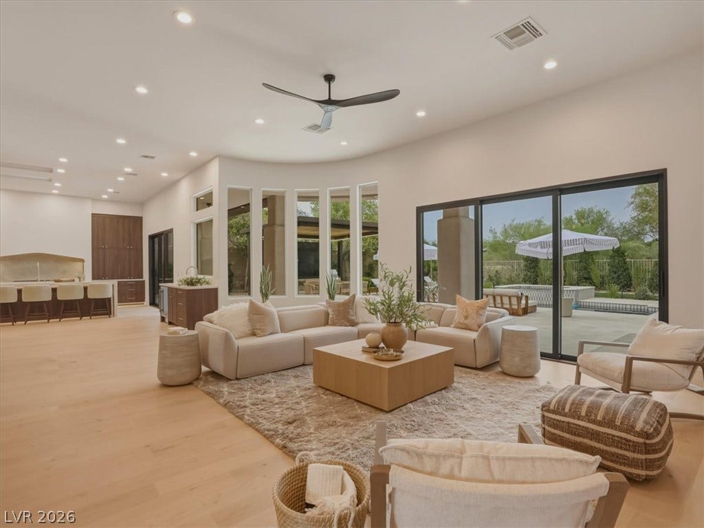 3 Isleworth Drive, Henderson, NV 89052 An airy living area offers ample natural light and a seamless transition to the inviting outdoor patio and pool.
