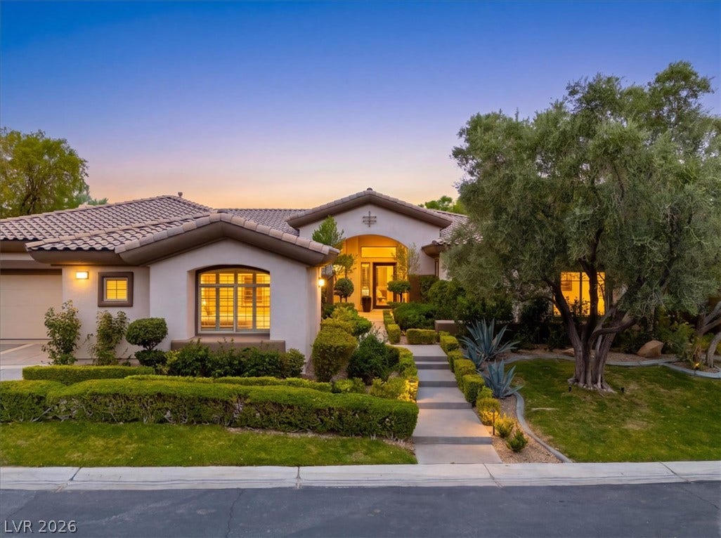 3 Isleworth Drive, Henderson, NV 89052 A graceful entry beckons guests up a well-lit path to this home, surrounded by sculpted landscaping.