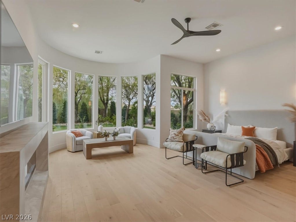 3 Isleworth Drive, Henderson, NV 89052 Floor-to-ceiling windows and light-toned hardwood flooring define this serene primary suite.