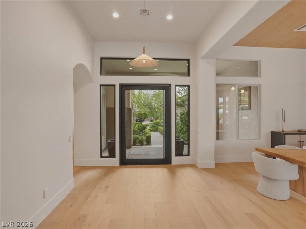 3 Isleworth Drive, Henderson, NV 89052 Enter into a bright, welcoming foyer with light wood flooring and sleek, modern windows.
