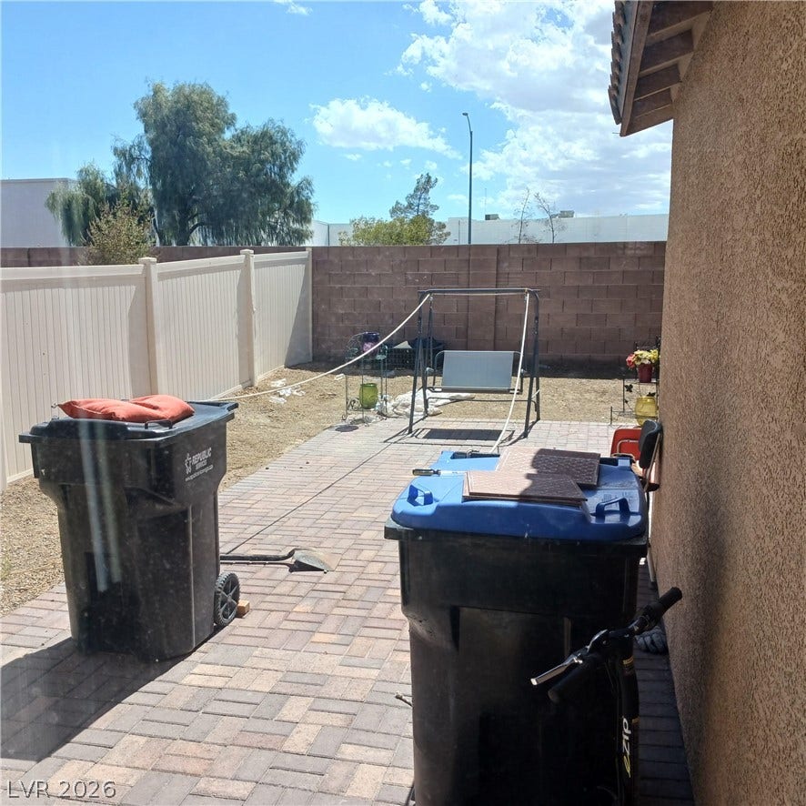 1705 Ronzard Avenue, North Las Vegas, NV 89032 A paved brick patio provides outdoor space along the side of the home.