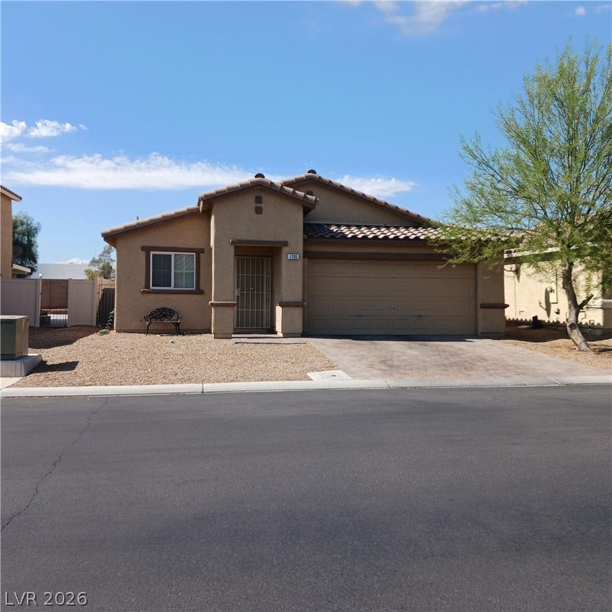 1705 Ronzard Avenue, North Las Vegas, NV 89032 Classic desert styling defines this single-story stucco residence with an attached garage.