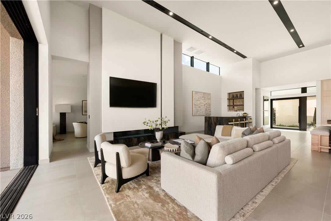 Towering ceilings and clean architectural lines define this expansive, light-filled contemporary living space.