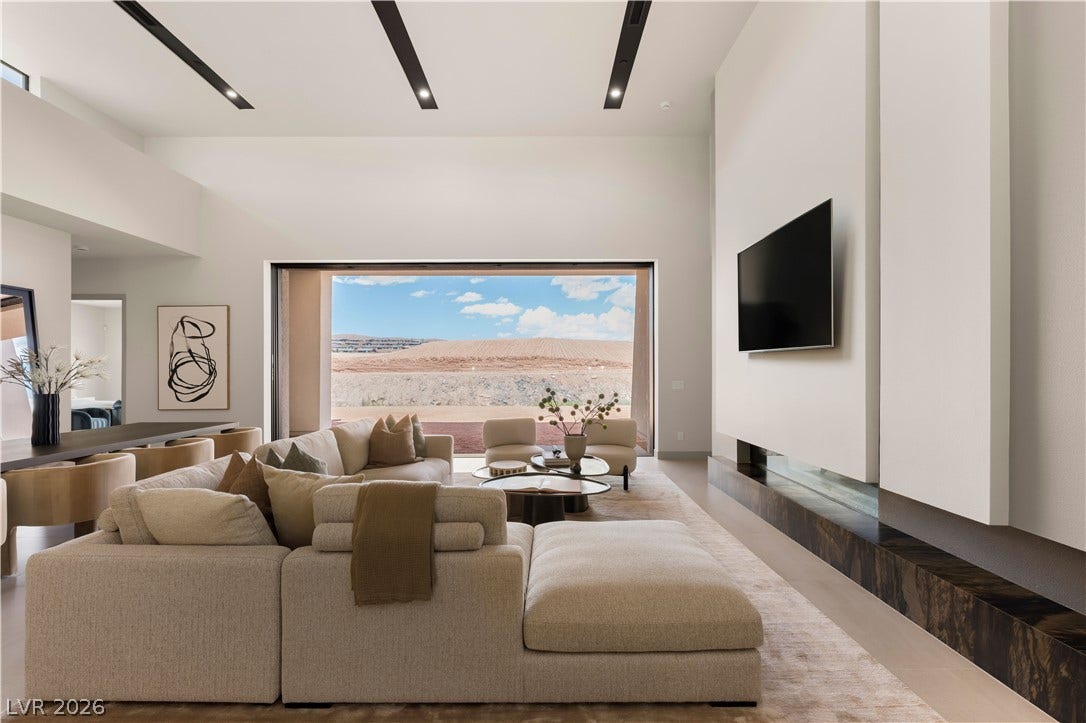 High ceilings and a massive sliding glass door define this modern living space.