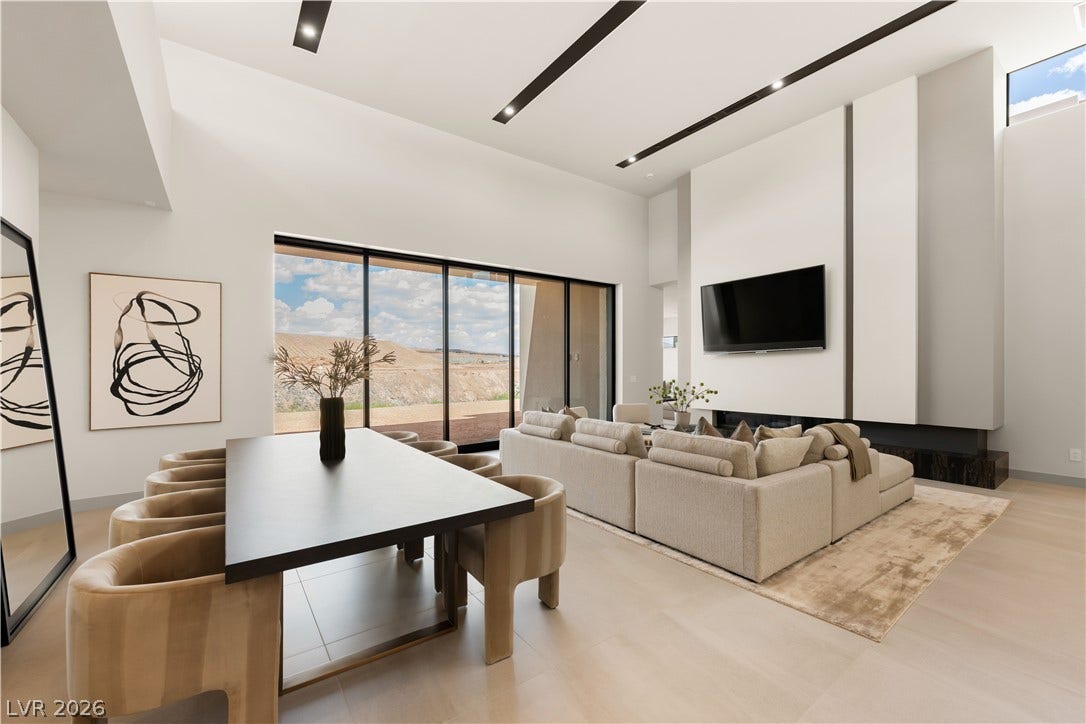 Massive sliding glass doors merge indoor comfort with dramatic desert views.