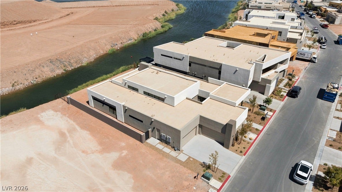 Sleek contemporary architectural design highlights this new construction property situated along a scenic waterway.
