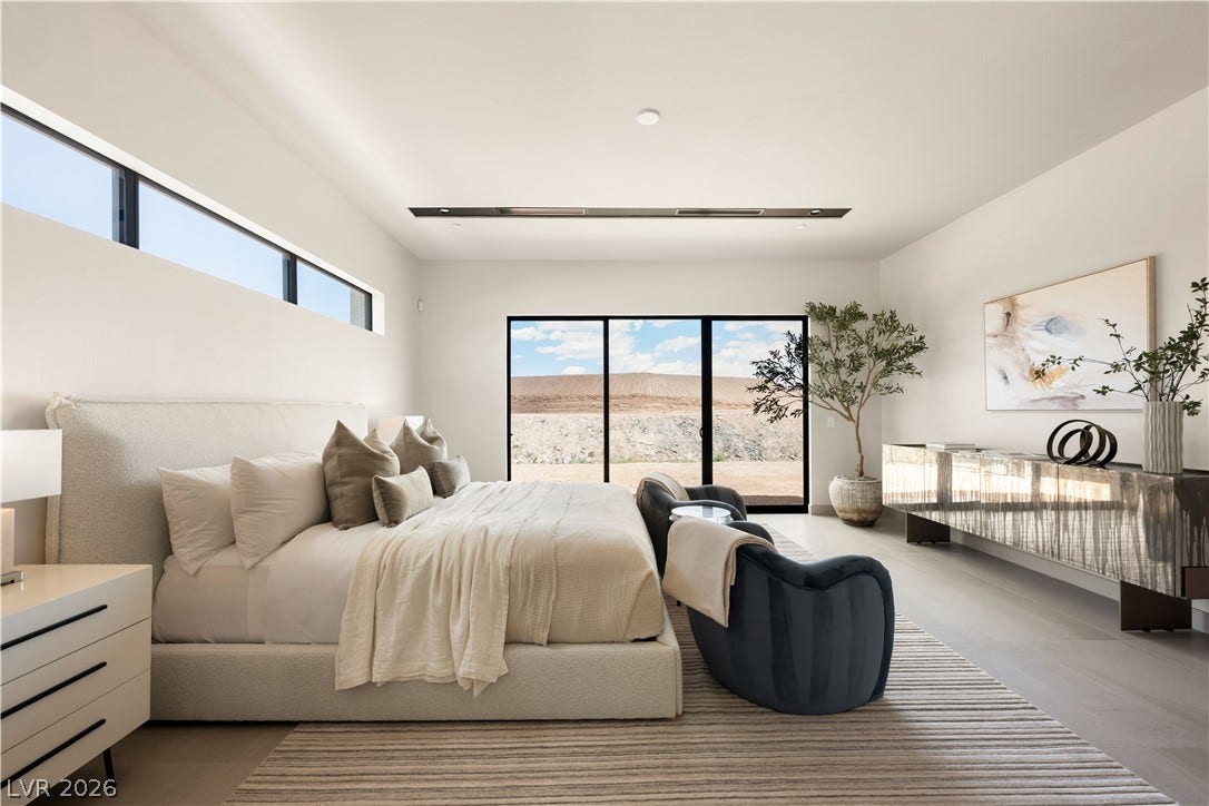 High clerestory windows and sliding glass doors bring abundant natural light into this minimalist bedroom.