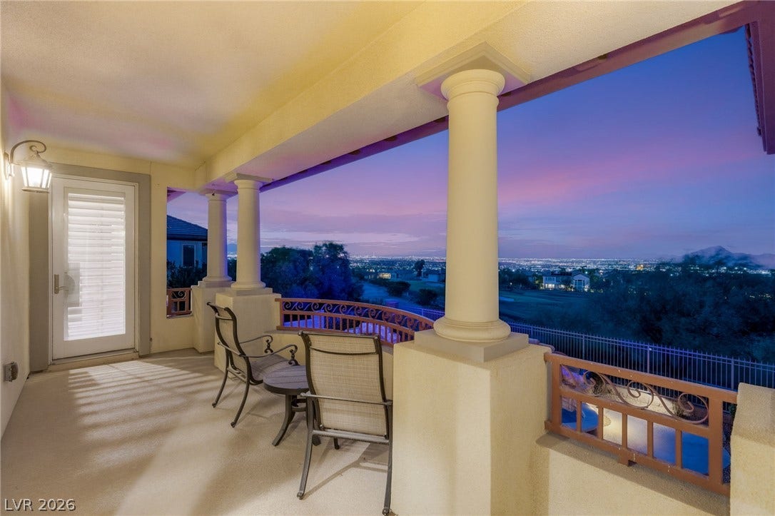 1372 Enchanted River Drive, Henderson, NV 89012 Classical columns frame sweeping city light and twilight views from this elevated covered terrace.