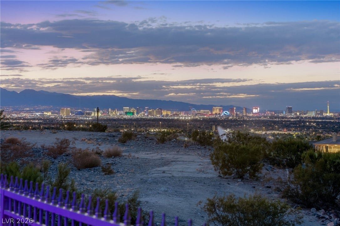 1372 Enchanted River Drive, Henderson, NV 89012 Sweeping panoramic views stretch across the glittering city skyline and surrounding mountain ranges.