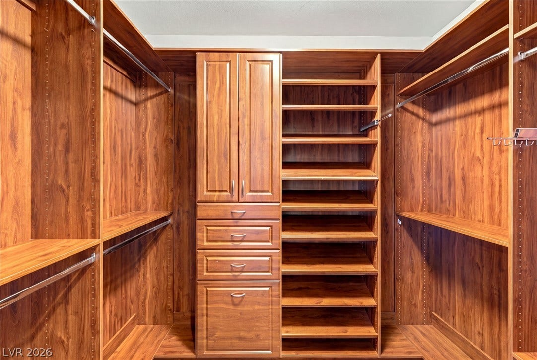 1372 Enchanted River Drive, Henderson, NV 89012 Rich wood built-ins maximize storage in this spacious walk-in closet.